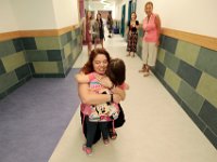 Molly Penney gives Pamela McDermott a hug upon seeing her for the first time, as students return to class at the Irwin Jacobs elementary school in New Bedford for the first day of class.   [ PETER PEREIRA/THE STANDARD-TIMES/SCMG ]